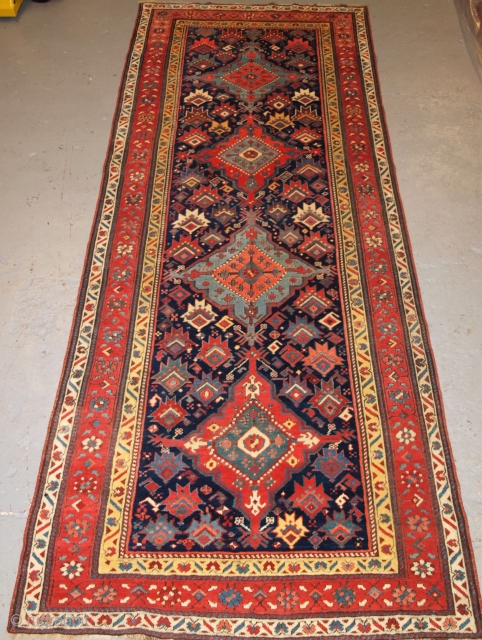 Antique South Caucasian runner with a repeat medallion design. http://www.knightsantiques.co.uk/596152/antique-south-caucasian-runner-with-outstanding-colour-and-design-late-19th-century/
Size: 9ft 11in x 3ft 10in (301 x 116cm).
               