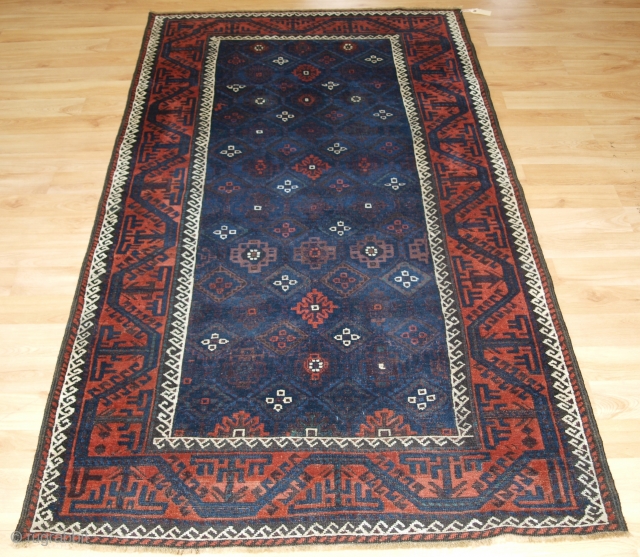 Antique Baluch rug from Western Afghanistan / Eastern Persia. A Baluch rug with a very unusual lattice design in blue.
http://www.knightsantiques.co.uk/540785/antique-baluch-rug-with-lattice-design-in-superb-blues-boat-border-late-19th-century/
Size: 6ft 11in x 3ft 8in (212 x 112cm).
     
