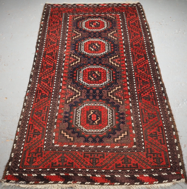 Antique Baluch tribal rug woven by the Salar Khani sub tribe. www.knightsantiques.co.uk

Size: 6ft 2in x 3ft 3in (187 x 98cm). 
Circa 1900.

The rug has four large turreted guls on an aubergine coloured  ...