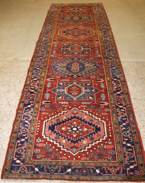 Antique Persian Heriz rug of good size, with traditional design. www.knightsantiques.co.uk Size: 12ft 4in x 3ft 7in (377 x 109cm).

Circa 1900/20.

The runner has a traditional Heriz medallion design on a warm red  ...