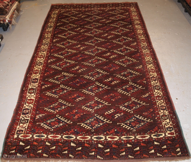 Antique Yomut Turkmen main carpet with the ‘Dyrnak’ gul design and tree design in the elem. www.knightsantiques.co.uk Size: 10ft 3in x 5ft 9in (313 x 175cm). 

Circa 1880.

The carpet has a rich  ...