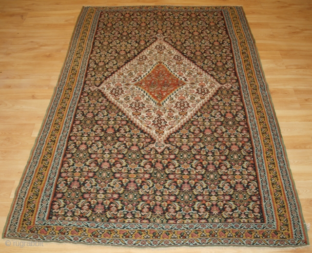 Size: 6ft 9in x 4ft 4in (205 x 132cm). www.knightsantiques.co.uk 

A fine Persian Senneh kilim with a traditional medallion design and herati to the field.

Circa 1900.

This is a good Senneh kilim with  ...