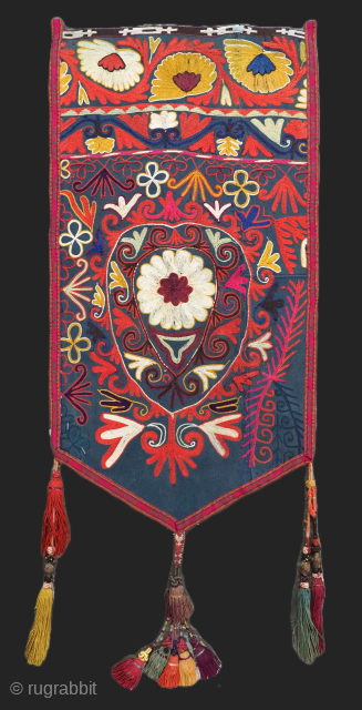 Antique Uzbek Lakai tribe uut kap ilgich, shield wall hangings for the yurt.
Size: 2ft 2in x 1ft 2in (66 x 36cm) excluding tassels.
Circa 1900.

Uut kap ilgich are shield shaped talismanic hangings that  ...