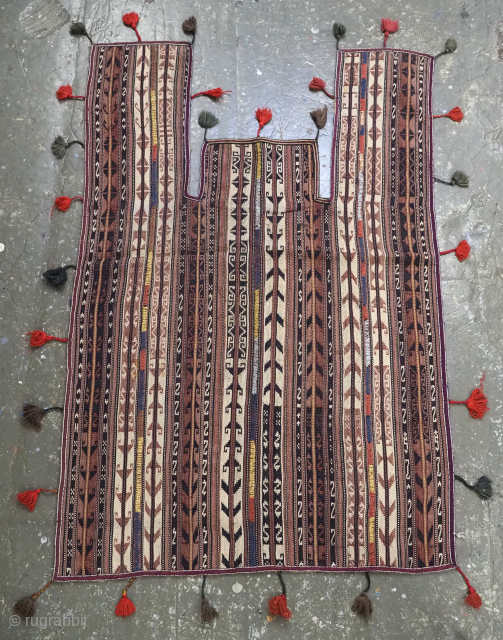 Antique Northern Afghan tribal ceremonial horse cover.

Circa 1900.
Size: 6ft 0inx 3ft 8in (182 x 114cm) excluding tassels.
This fine horse cover is made from narrow flat woven strips with weft work decoration, which  ...