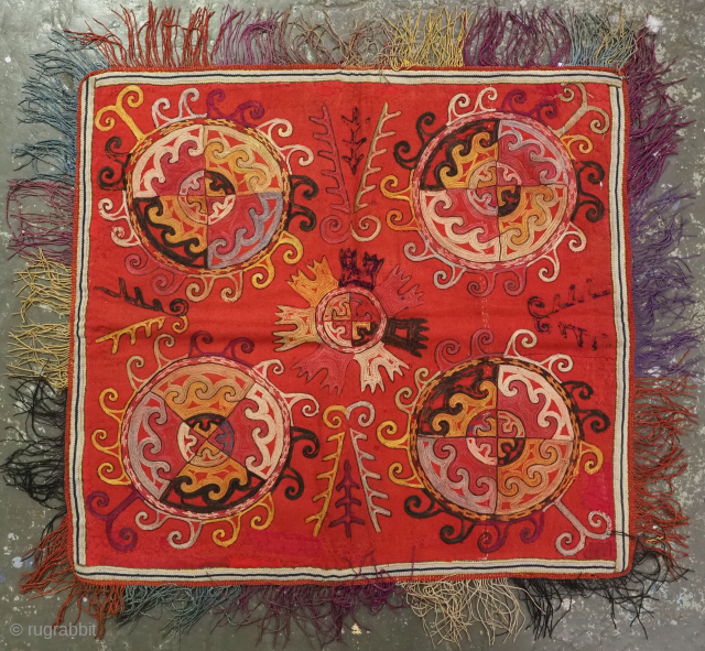 Antique Uzbek Lakai tribe ilgich, dowry wall hanging for the yurt.
Size: 1ft 11in x 1ft 10in (59 x 55cm) excluding tassels.
Circa 1880.
Ilgich are embroidered hangings that usually formed part of a brides ...