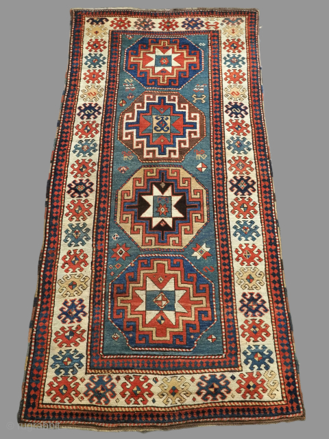 Antique Caucasian Kazak long rug with Memlinc guls within octagons on a green ground.
2nd half 19th century.
Size: 8ft 8in x 4ft 3 in (265 x 130cm).
A superb Kazak long rug with a ...