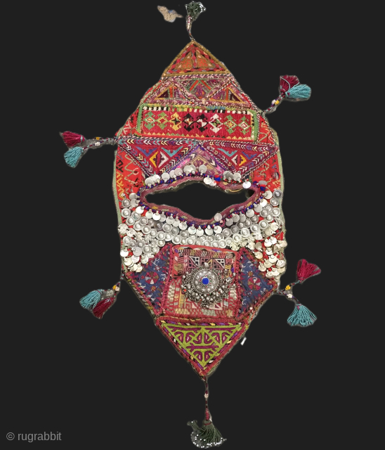 Antique Turkmen child's bib / tunic, decorated with white metal discs and other devices to ward off evil. A beautiful collectors display object.          