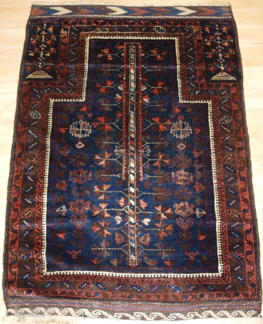 Antique Baluch blue ground prayer rug with 'tree of life' design. www.knightsantiques.co.uk 

Late 19th century.

A good blue ground Baluch prayer rug with tree of life design to the field. The hand placements  ...