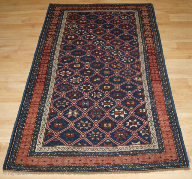 Antique Caucasian Seichur rug with star and lattice design. www.knightsantiques.co.uk 

Circa 1880.

This charming rug has a dark indigo blue field covered with a fine diamond lattice, with each diamond containing a eight  ...