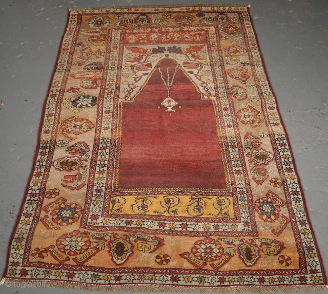 
***£695/$925***
Antique Turkish Oushak region prayer rug of classic design with soft pastel colours. www.knightsantiques.co.uk 
Size: 5ft 11in x 3ft 8in (180 x 111cm). 
Late 19th Century. 

The rug is of a traditional  ...