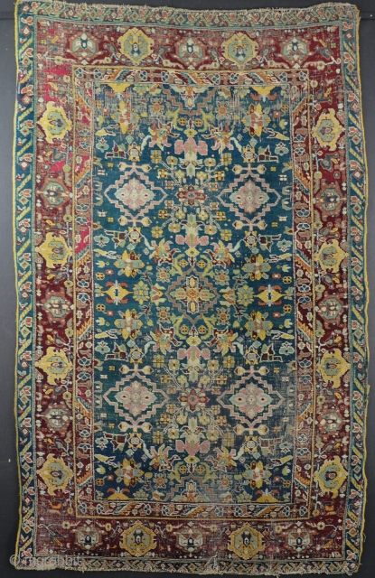 A beautiful Agra rug in horrible condition! Fabulous ground colour and drawing that is reminiscent of much earlier weaving. Mid-19th century. 197x120cm           