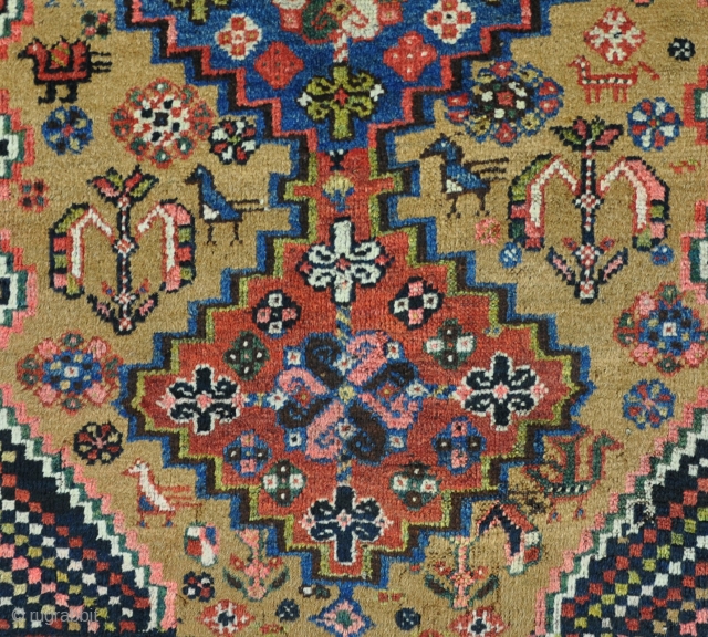 Old Khamseh rug on scarce camel ground. Mainly in good pile, slightly lower in places. Clean and floor ready. Circa 1900.            