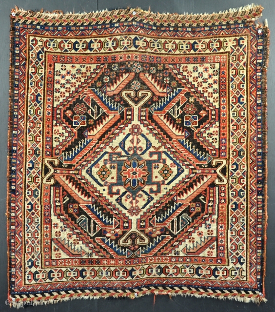 Antique Qasgai square rug, nicely made item in very unusual format. Low pile with some corrosion, bite to top right corner, slight tear in middle, easily fixed if required, 19th century.  