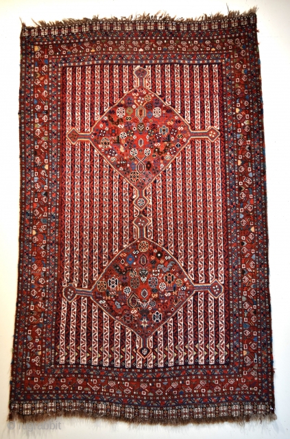 An antique South West Persian Khamseh tribal rug. 2 medallions filled with chickens and other filler elements float on a rare cane stripe ground. All natural dyes, all wool construction. A genuine  ...