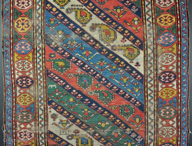 A good Karabag rug with juicy colours, including a particularly vivid green, worn and various problems, but very cheap and possibly restorable. 19th century. 223 x 110      