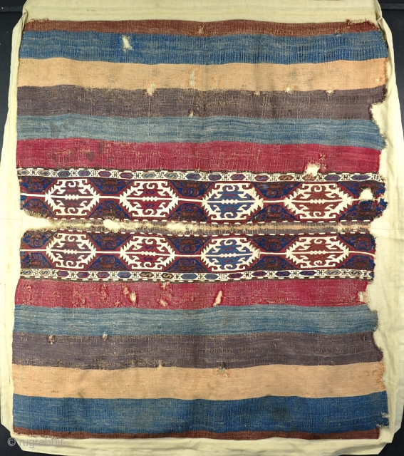 An antique Anatolian Kilim (Mafrash?)mounted on cloth complete with beautifully made collapsible stretcher and Velcro. Obvious damages and some local surface staining but big and graphic and sensibly priced. Mid 19th century.  ...