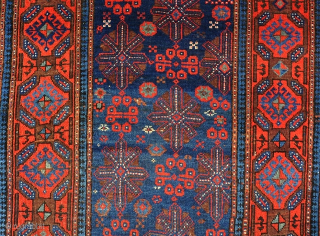 An Old Quchan Kurd rug, good dyes and shiney wool, clean, good condition and floor ready. Velcro hanging sysetm to rear. Circa 1900. 187x104cm         