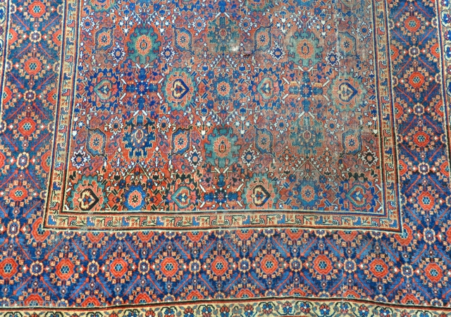 An antique Khorrasan carpet, some wear but complete, still retaining its original sides and fine blue kilim ends. 462x220cm. Early 19th century           