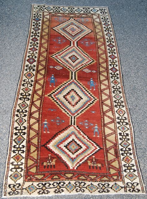 Very cool Northwest Persian long rug. Polychromatic medallions and stylized figures on a terra cotta color field.                