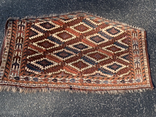 Yomud Turkoman Asmalyk, late 19th century, 2-1 x 3-8 (64 x 112), rug was hand washed, good pile, left edge has long  tare, 4-5 small holes, 4 green silk highlights in  ...