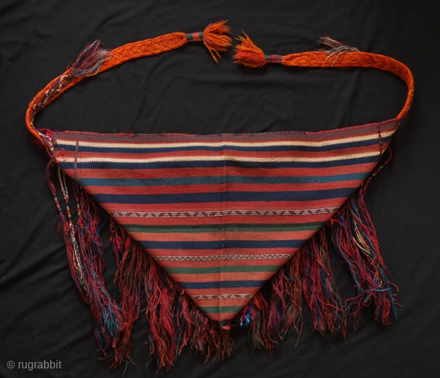 Tribal baby carrier, Kurdish from eastern Anatolia. 1920s or so.  It adorned with long braided tassels and additional filikli or long goat hair tassels.  A thick, hand braided band has  ...
