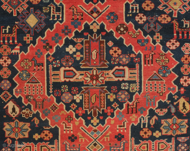 Shirvan rug, 1900 or so. Serrated double lattice-like medallions on a deep indigo blue ground. Lots of wonderful animal figures and other elements in the field. Some of the design ...