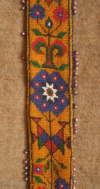 Sivas area glass beaded belt from the 1920s to 1930s. Yellow ground. Beautifully articulated floral motifs, Turkmen gol-like medallions and a rooster on each end.  Leather backing.  5.5 x 74  ...