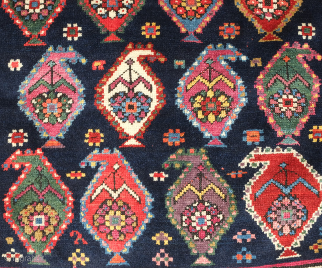 Genje rug, 19th century.  A real blitz of color on a midnight indigo field.  Pink, purple, apricot, green - at least 11 colors.  Overall good condition with two small  ...