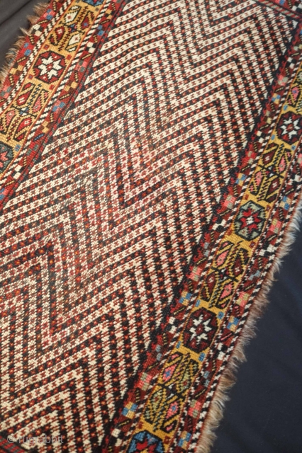 Lori or Khamseh mafrash panel, 19th century. Mezmerizing zigzag design surrounded by a yellow border of eight-pointed stars in florettes and botehs arranged in a floral form.  Some repiling in the  ...
