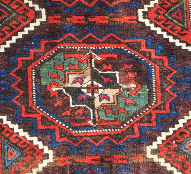 Baluch rug, Khorasan, 19th century.  Salor guls and a rich array of colors including purple and seafoam green.  Parts of the selvedge need some re-wrapping. 96 x 165 cm  