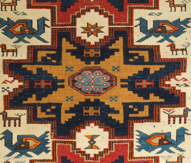 Lesghi Star rug with Akstafa birds, 19th century. Fantastic drawing on a white ground. The blacks in the top part of the border shows corrosion but otherwise in good condition.  116  ...