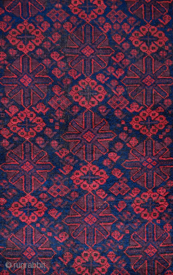 Baluch rug, Khorasan, Late 19th ceuntury. Overall mina khani design in a fine weave in  brooding palette.  Derived Yomut Turkmen "boat" border design. In good condition. The field has a  ...