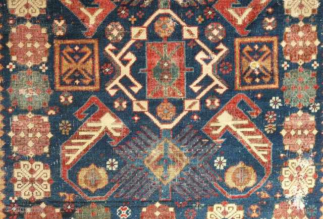 Shirvan rug, 19th century.  Talish guls surrounding the field.  Wonderful abstracted eagle and dragon or phoenix and phoenix motifs in the field surrounded by multiple floral borders.  Obvious wear  ...