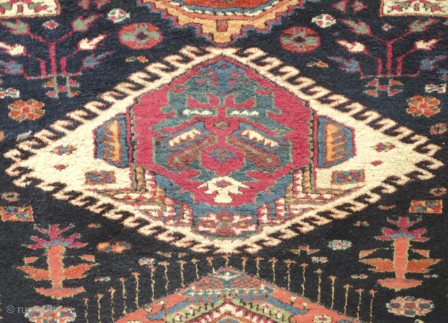 A Sauj Bulak long rug, 19th century. Extraordinarily fine weave. Cloud band star and serrated medallions in the deep indigo field. Apricot main border. A couple holes can ...