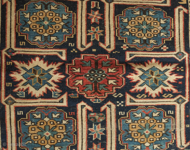 Kuba rug, 19th century. Wonderful floral star and blossom motifs between lattices.  Lower pile and some wear but all there and visible.  Crisp drawing.  Intriguing little motifs interspersed in  ...