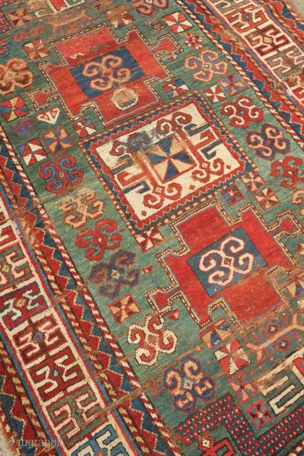Fachralo green ground rug, 19th century. Wonderful field of green, kochanak border and elibelinde motifs on both ends of the field.  Obvious wear but all there. 142 x 234 cm  
