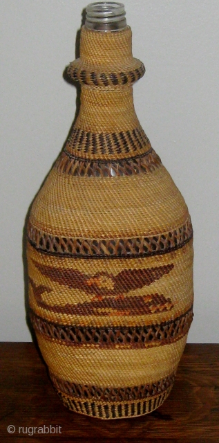 Antique Native American Northwest Coast Nootka-Makah polychrome twined bottle basket, consisting of a bottle covered with fine weave of cedar bark and bear grass.  Solid bands alternating with open lattice work.  ...