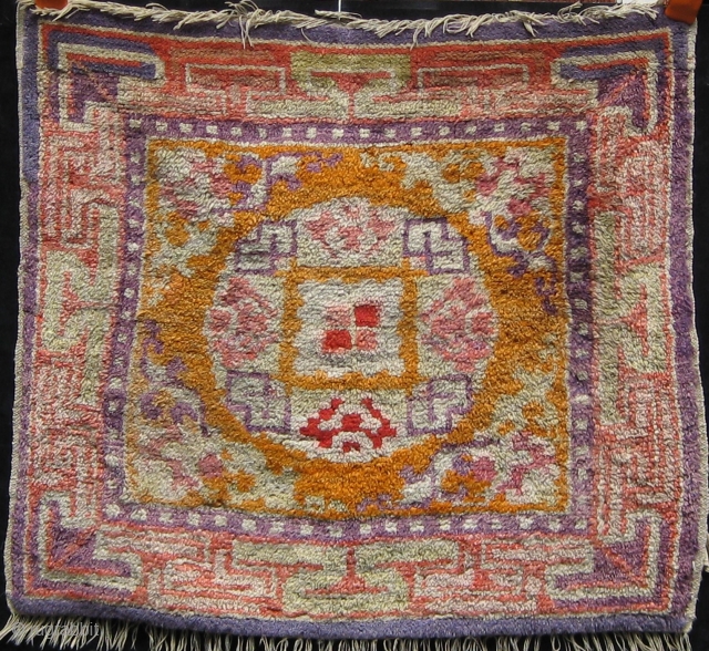 Antique Chinese seat cover, late 19th Century.  In good condition.  Ends expertly rewoven.  Mostly full pile.  All dyes appear natural with the possible exception of the mauve color  ...