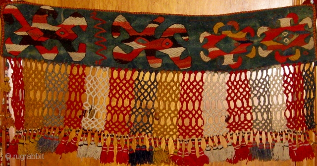 Early 20th Century Uzbek trapping with unusual shamanistic motifs. Wool and felt.  35" by 17" including fringe.  Please ask for additional photos.         