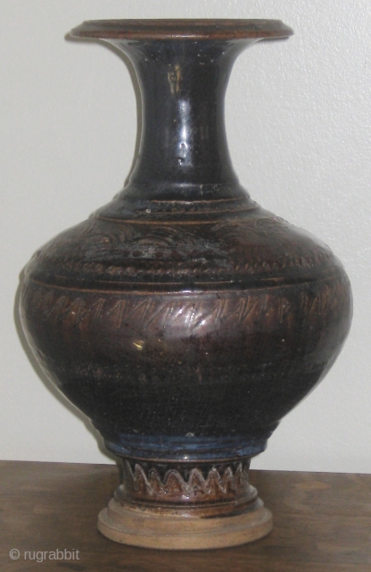 Angkor period (12th Century) Khmer glazed baluster jar, with incised scalloped decoration on shoulder and foot, and carved rings on the mouth, shoulder, and foot.  Please ask for additional photos.  