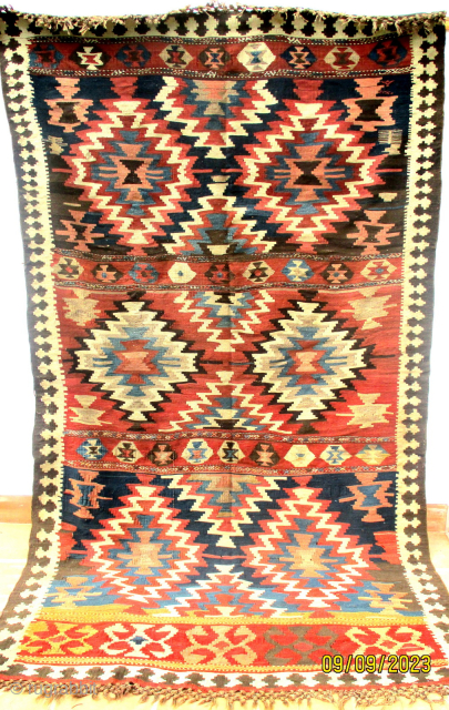 OLD PERSIAN SHAH SAVAN KILIM dating from the first half of the last century and attributed to the Shah Savan of the Khamseh group. It is woven on mid brown hand spun  ...