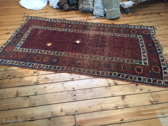 4'2" x 7'8" Kurdish two holes and worn rug / fragment. As-found, no touch ups, appears to be fairly clean.             