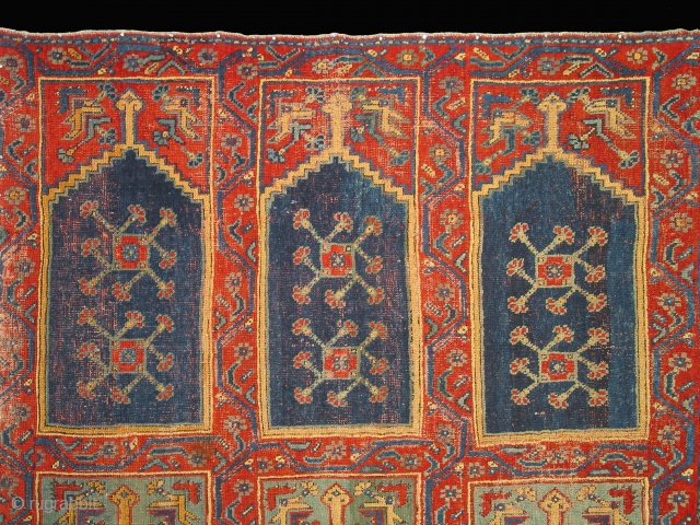 Ushak region carpet fragment of a large mosque prayer carpet with three rows of three prayer niches, late 18th century, 400cm high and 245cm wide. Condition: good overall even pile.
Compared to most  ...