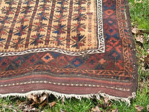 Camel Ground Baluch Rug w/Maimanna border

Size 38 1/2" x 65 1/2" at greatest dimensions
End treatment Upper kilim end 41/2 ", lower kilim end 5 1/2"

A few tassels remain on the upper right  ...