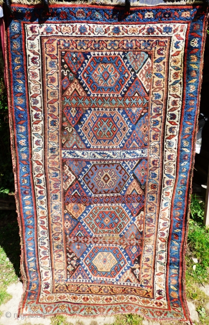 Kurdish rug. Wear to main ground with foundation showing in places. Sides need securing and tape has been added to reinforce them. Ends have been poorly secured. Great colours and a usable  ...