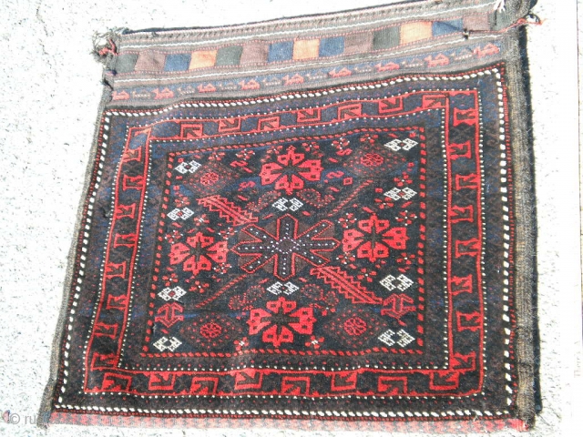 Baluch storage bag  ca.1920  2'6"x 2'7" Full pile Tightly woven.  A dark piece will require a lot of light to see all of the color. Small amount of moth  ...