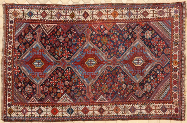 RUG NO : 20 
 
SIZE : 330 x 198 
 
TYPE : Antique 1900 
 
ORIGIN : Iran 
 
DESIGN : Khamseh 
 
CONTENT : Wool on wool 
 
BACKGROUND COLOUR  ...