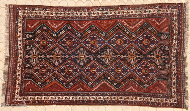 RUG NO	:	40
SIZE	:	393 x 233
TYPE	:	Antique 1900
ORIGIN	:	Iran
DESIGN	:	Khamseh Niriz
CONTENT	:	Wool on wool
BACKGROUND COLOUR	:	Ivory
BORDER COLOUR	:	Blue.


this is a rare carpet.it is  a khamseh -i did indicate that it is a niriz,however,it  could be from Bowanat to  ...