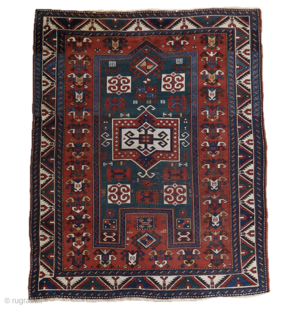 Antique rare green ground Kazak Fachralo. cm 185x145 dated

The green field at the base of the rug shows low pile, adding to its antique charm. Authentic corrosion is visible on the brown  ...