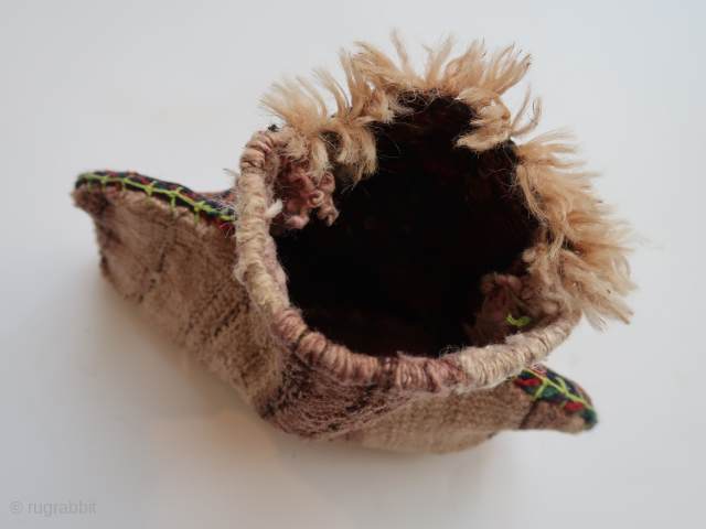 Small bag, pouch, fragmented . Ca :  33 cm . x 27 cm . Some  zoomorphic  elements  on the front side. ( Camel ? )  North West  ...